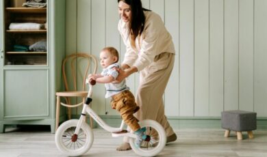 A baby biking inside the house
